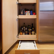 Seen here is a kitchen designed by Roberta furniture, shelf, shelving, orange