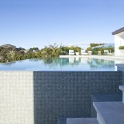Overview of pool and stairs. - Overview of condominium, estate, home, house, leisure, property, real estate, resort, swimming pool, villa, teal