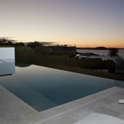 Evening sunset over the pool. - Evening sunset architecture, estate, evening, home, house, morning, property, real estate, reflection, roof, sky, sunlight, swimming pool, water, gray, black