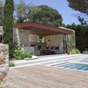 View of the patio area and pool.  backyard, estate, home, house, outdoor structure, property, real estate, villa, gray