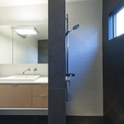 Open shower in bathroom with Basalt tiles, oak architecture, bathroom, bathroom accessory, bathroom cabinet, daylighting, interior design, product design, room, sink, black, white