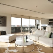 Penthouse living space with white couches, a circular ceiling, floor, flooring, furniture, hardwood, home, interior design, interior designer, living room, property, real estate, room, wall, window, wood, wood flooring, white, orange