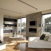 Pale timber flooring and white walls help to floor, interior design, living room, real estate, window, brown, white