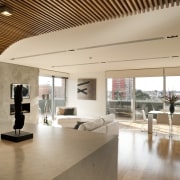 Penthouse interior featuring a deep curved timber batten architecture, ceiling, floor, flooring, house, interior design, living room, property, real estate, gray, brown