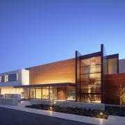 Exterior view of the home from the pool.The architecture, building, commercial building, corporate headquarters, elevation, estate, facade, home, house, lighting, mixed use, property, real estate, residential area, sky, blue