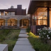 View of entrance to the home. Windows and architecture, backyard, courtyard, estate, facade, home, house, landscape, landscape lighting, landscaping, lighting, patio, property, real estate, residential area, siding, window, yard, brown, gray