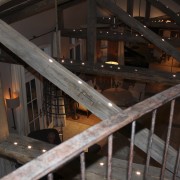 The kitchen of this home was designed by beam, iron, metal, stairs, structure, wood, black