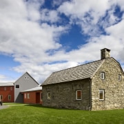 Architect Alexander Gorlin distilled the essence of a barn, building, cloud, cottage, croft, farm, farmhouse, grass, highland, home, house, property, real estate, rural area, sky, gray