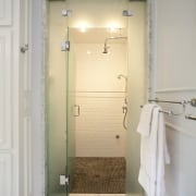 The shower room is completely enclosed so it bathroom, door, floor, home, interior design, plumbing fixture, room, tile, gray