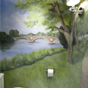 A painted wall mural enlivens the small toilet artwork, bathroom, ceiling, green, home, house, interior design, mural, painting, room, wall, gray, green