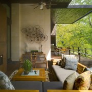 Designed as an outdoor room, the rear deck home, house, interior design, living room, outdoor structure, real estate, brown