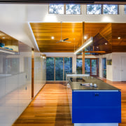 Strong architectural lines define this new kitchen. The architecture, ceiling, floor, flooring, house, interior design, brown