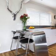 A handcrafted stainless steel breakfast bar creates a chair, countertop, floor, flooring, furniture, interior design, kitchen, loft, product design, room, table, gray, white