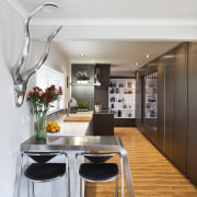 A view of the narrow kitchen area. - interior design, kitchen, table, white