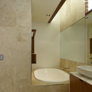 A picture of travertine tile, mirror and warm architecture, bathroom, daylighting, home, interior design, real estate, room, brown