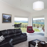 The flooring for this Otago home was chosen architecture, ceiling, home, house, interior design, living room, real estate, window, gray