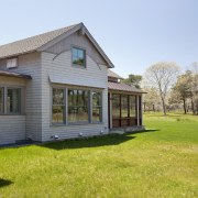 Exterior view of the home from the lawn. backyard, cottage, estate, facade, farmhouse, grass, home, house, property, real estate, siding, window, yard