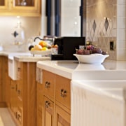 A close up view of the kitchen cabinetry. cabinetry, countertop, cuisine classique, furniture, interior design, kitchen, room, white, orange