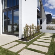 This 'Life at Home' home features paving from architecture, building, estate, facade, grass, home, house, lawn, property, real estate, residential area, walkway, window, white