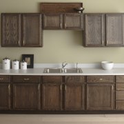 Seen here is a kitchen with a Kohler bathroom, bathroom accessory, bathroom cabinet, cabinetry, chest of drawers, countertop, cuisine classique, furniture, hardwood, kitchen, product design, sink, wood stain, brown