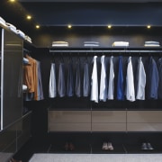 Seen here is a storage system/closet designed and closet, furniture, room, wardrobe, black