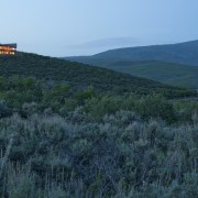 Exterior view from afar of a home designed biome, ecoregion, ecosystem, escarpment, farm, field, grass, grass family, grassland, highland, hill, landscape, meadow, mountain, plain, plant, plant community, prairie, rural area, shrubland, sky, tree, vegetation, wilderness, teal