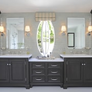 A pivoting oval feature window  provides an bathroom, bathroom accessory, bathroom cabinet, cabinetry, countertop, cuisine classique, furniture, interior design, kitchen, room, sink, gray, black