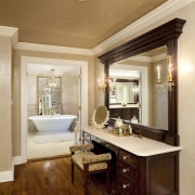 A large mirror doubles the apparent size of ceiling, floor, flooring, furniture, hardwood, home, interior design, living room, real estate, room, wall, wood, wood flooring, orange, brown