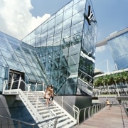 Clad in steel and clear glass, the Louis architecture, building, commercial building, condominium, corporate headquarters, facade, headquarters, metropolitan area, mixed use, sky, structure, tourist attraction, white, teal