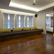 This renovated townhouse interior features cantilevered cabinets with ceiling, floor, flooring, hardwood, interior design, laminate flooring, living room, property, real estate, room, window, wood, wood flooring, brown