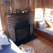 Before a major renovation, the original fireplace is fireplace, floor, flooring, hardwood, home, living room, property, real estate, room, wood, red