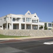 Before image of beachfront apartment complex that was apartment, building, commercial building, condominium, corporate headquarters, daytime, elevation, estate, facade, home, house, mixed use, neighbourhood, property, real estate, residential area, sky, suburb, blue, gray