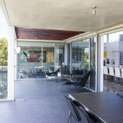 A terrace on this new home overlooks the architecture, balcony, daylighting, house, interior design, patio, property, real estate, roof, window, gray, white