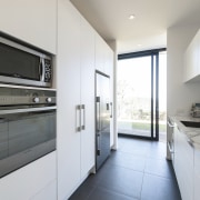 Holistic design by Yellowfox accentuates house and site countertop, home appliance, interior design, kitchen, real estate, white