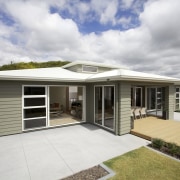 This Tauranga show home has several features with elevation, estate, facade, home, house, property, real estate, residential area, roof, gray