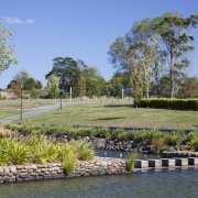 James Hardie Building Products used on House Karaka bank, estate, grass, landscape, landscaping, plant, pond, real estate, reflection, sky, tree, water, waterway, wetland, teal
