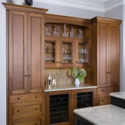 Avid entertainers, the owners of this remodeled kitchen cabinetry, chest of drawers, countertop, cuisine classique, furniture, interior design, kitchen, wood, wood stain, brown, gray