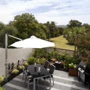 New outdoor living area, part of a 1970s backyard, home, outdoor furniture, outdoor structure, patio, property, real estate, roof, table, white, gray