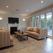 The renovated living area opens to a new ceiling, estate, floor, flooring, hardwood, home, house, interior design, living room, property, real estate, room, window, wood flooring, gray, brown