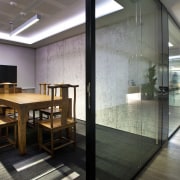 This meeting space in the Beijing office of architecture, ceiling, floor, flooring, interior design, lobby, gray, black