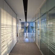 A simple corridor behind the reception area of architecture, ceiling, daylighting, glass, interior design, lobby, real estate, gray