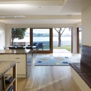 Coastal connections this house by Richard Middleton opens countertop, estate, floor, flooring, hardwood, house, interior design, kitchen, real estate, room, window, wood flooring, gray, brown