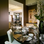 This formal dining area is positioned beside a dining room, furniture, home, interior design, living room, restaurant, room, table, brown