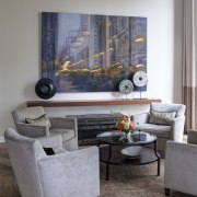 This intimate seating area is at one end coffee table, floor, furniture, home, interior design, living room, room, table, wall, gray