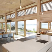 Designed to maximise a spectacular waterfront view, this daylighting, house, interior design, real estate, window, wood, white, orange