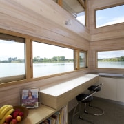 This workbench beneath a sliding window incorporates deep architecture, ceiling, daylighting, furniture, home, house, interior design, real estate, table, window, wood, brown, gray