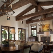 In the family room of this Mediterranean-style Californian beam, ceiling, dining room, interior design, living room, real estate, room, brown