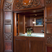 Inspired by classic childrens stories, this concealed retreat cabinetry, door, estate, interior design, wood, wood stain, red