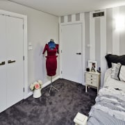 Tucked beneath a towering gum tree canopy, this bedroom, floor, flooring, home, interior design, real estate, room, gray