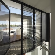 An internal staircase leads to the roof deck architecture, condominium, daylighting, door, glass, house, interior design, real estate, window, window blind, window covering, window treatment, gray, black